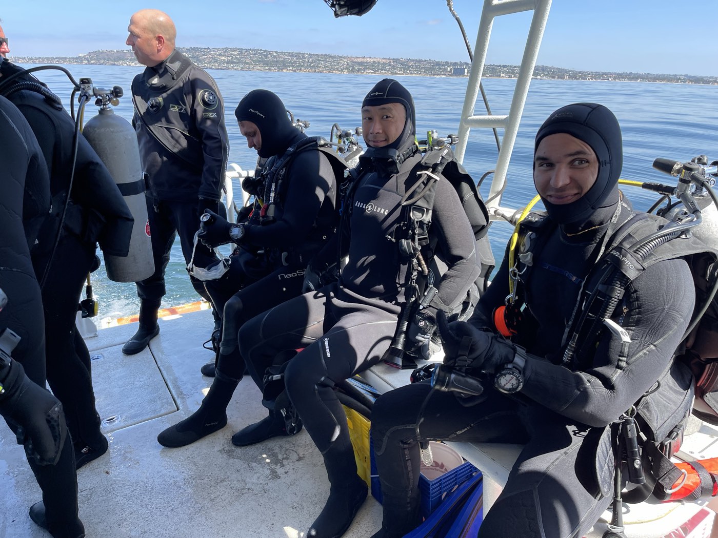 Divers seated on the Marissa's benches in full kit before a dive