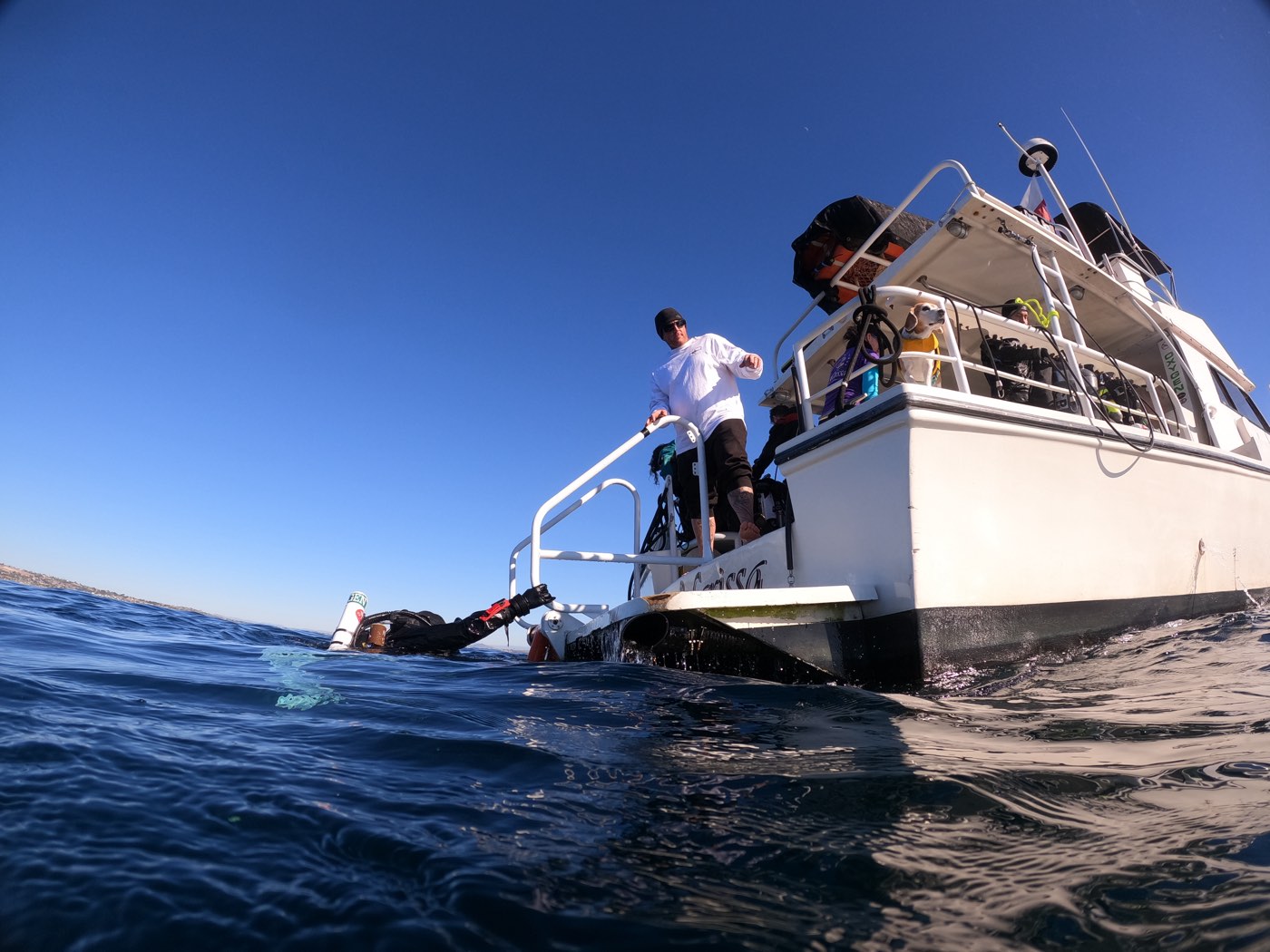 A diver stepping off the Marissa's swim step into the water